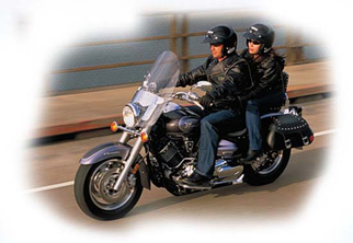 two people riding a black motorcycle